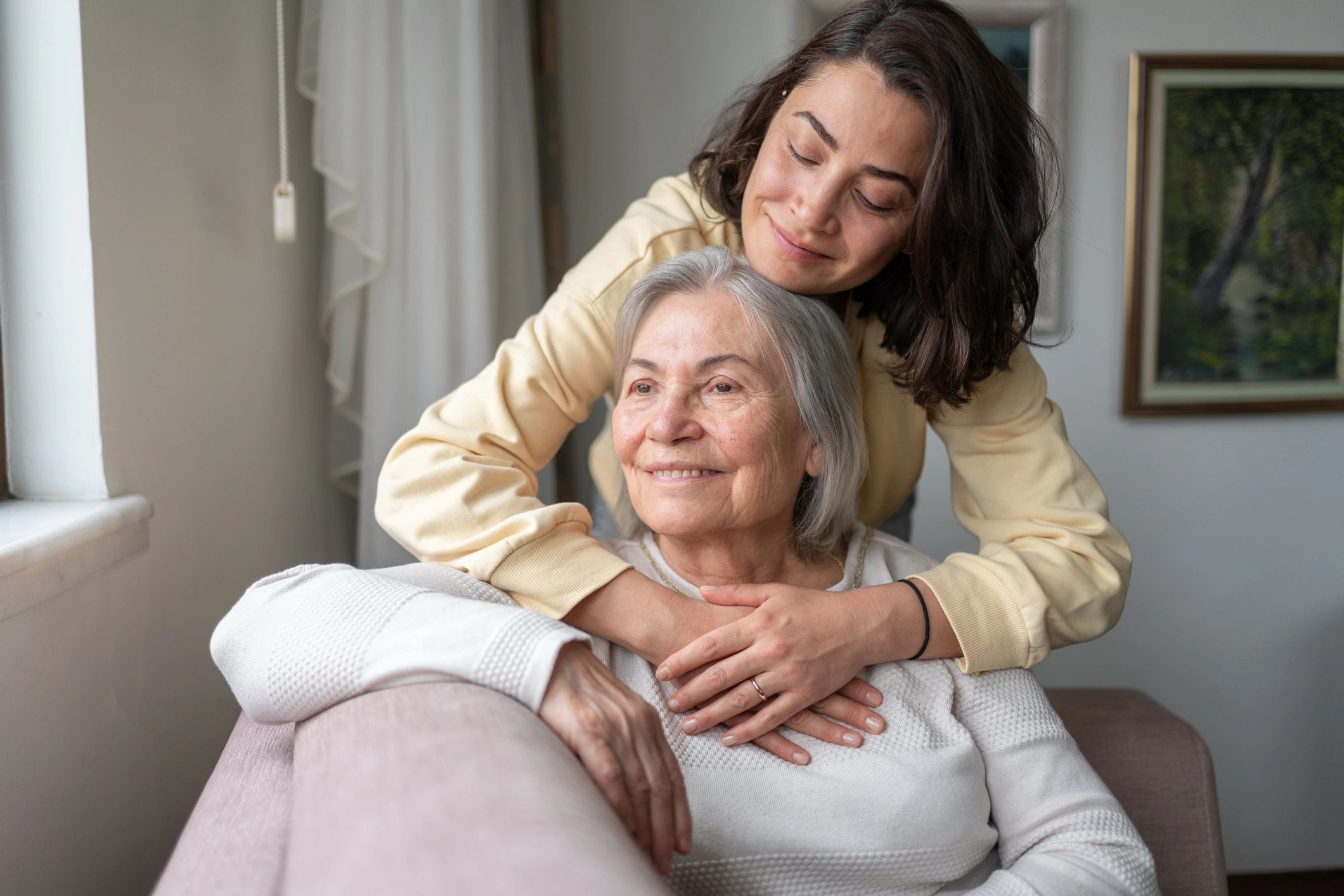 Compassionate caregiver supporting a senior at home
