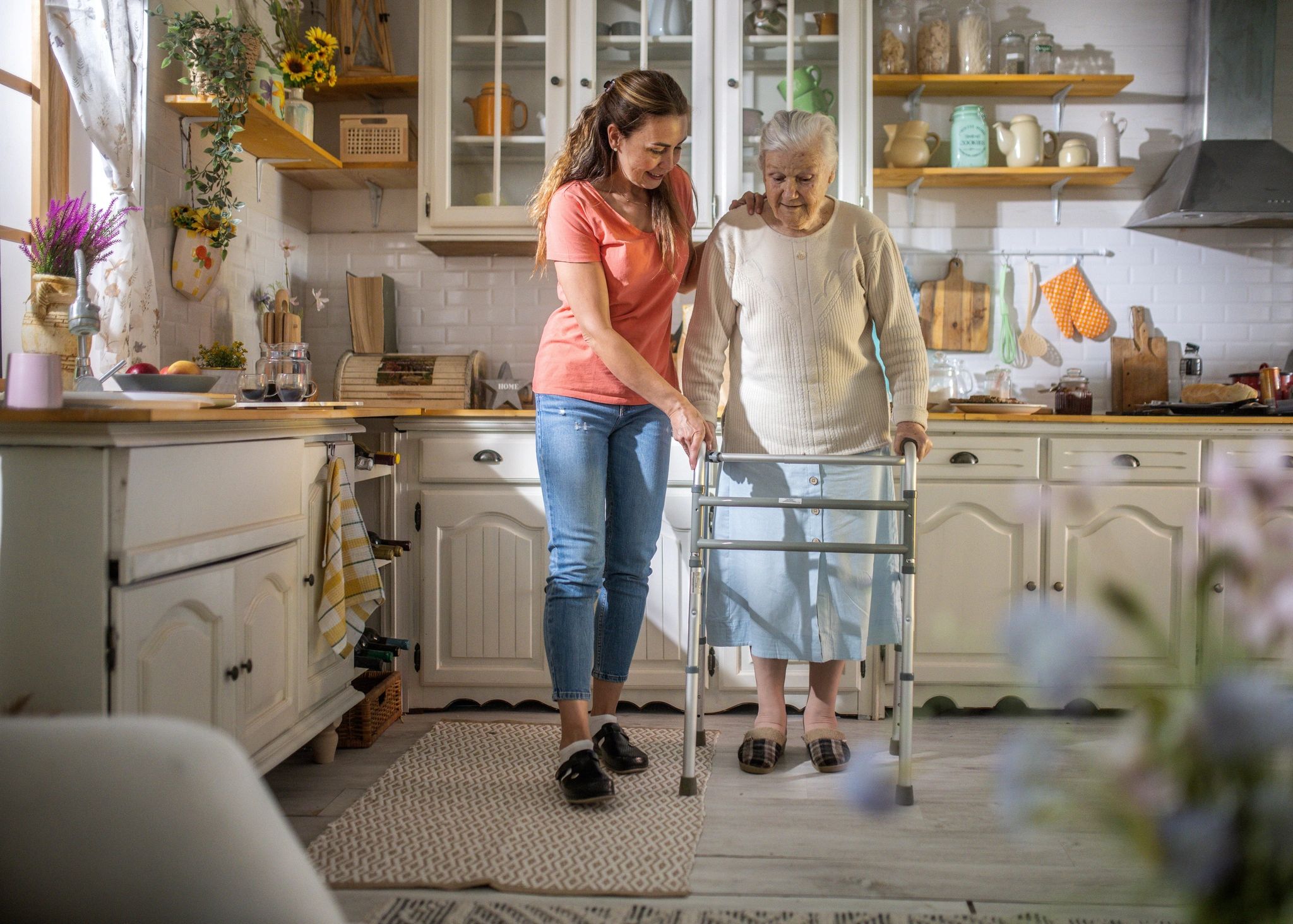 Caregiver helping elderly woman with daily activities